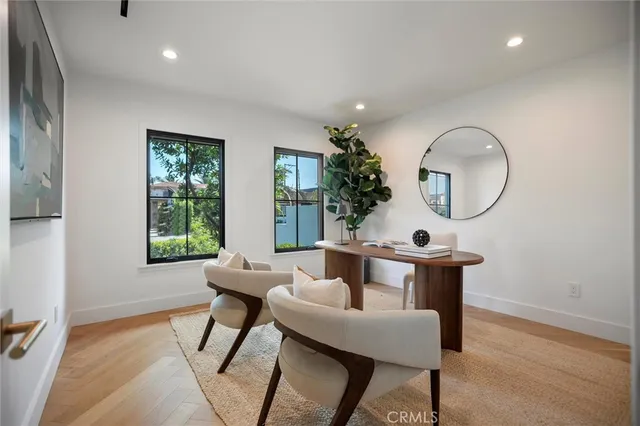 a bedroom with a bed and a potted plant