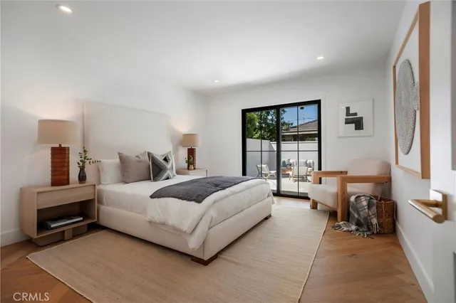 a bedroom with a bed and a mirror