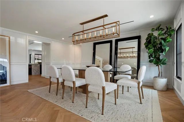 a view of a dining room with furniture and a chandelier
