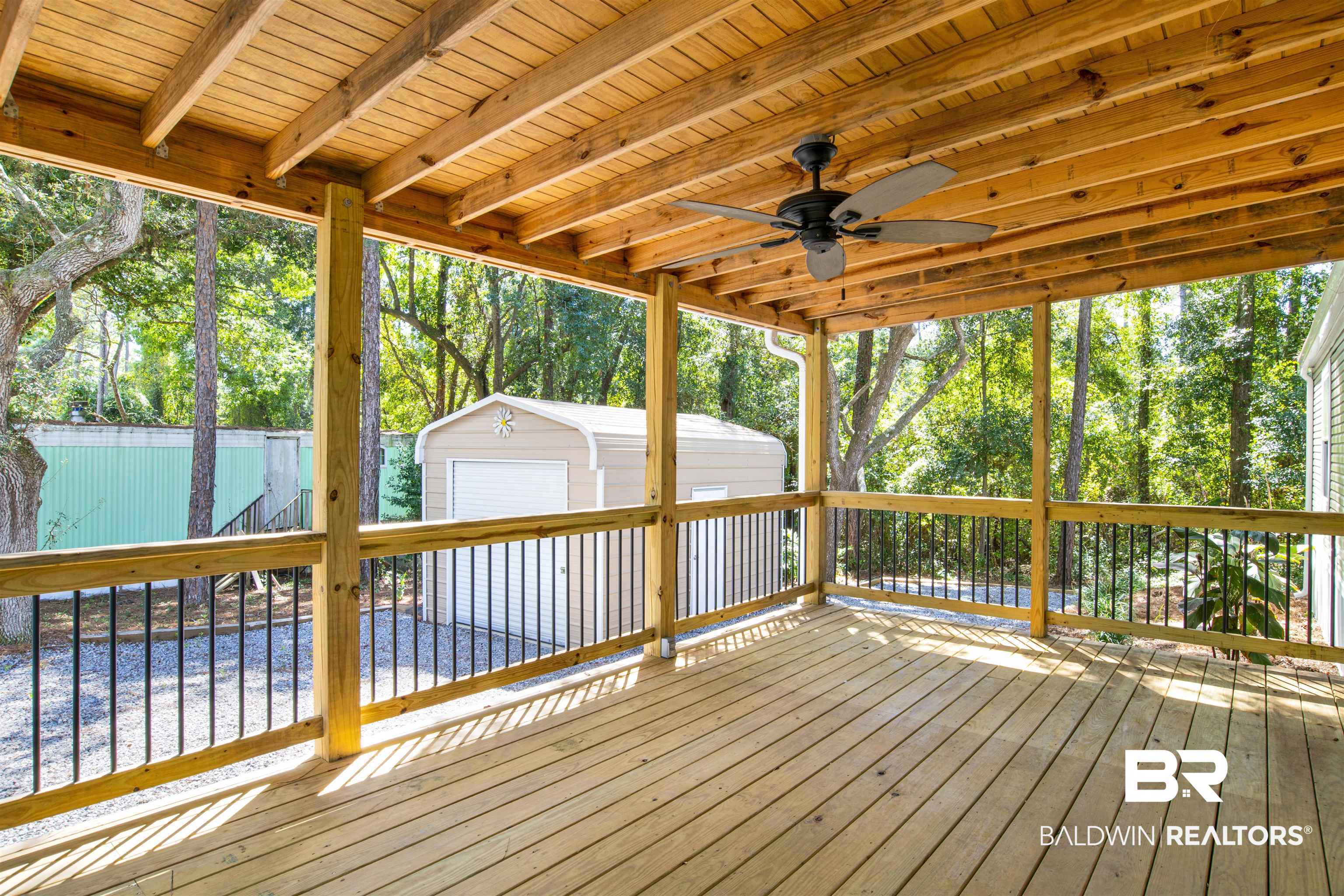 1411 Ridgewood Drive Lillian, AL 36549 - Photo 28 of 30 Deck with ceiling fan, an outdoor structure, and a garage