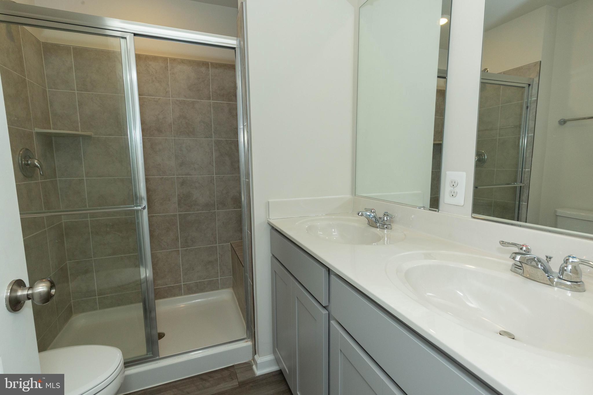 158 Cooperage Road Inwood, WV 25428 - Photo 25 of 25 a bathroom with a shower sink vanity mirror and toilet