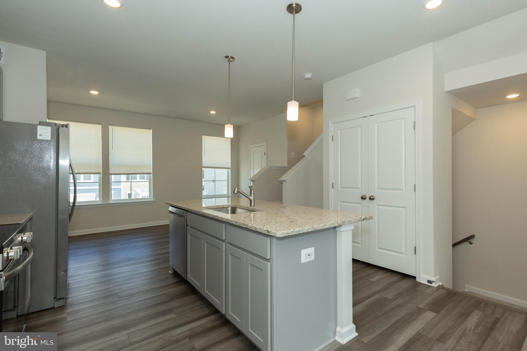 158 Cooperage Road Inwood, WV 25428 - Photo 9 of 25 a kitchen with center island wooden floor appliances and a window