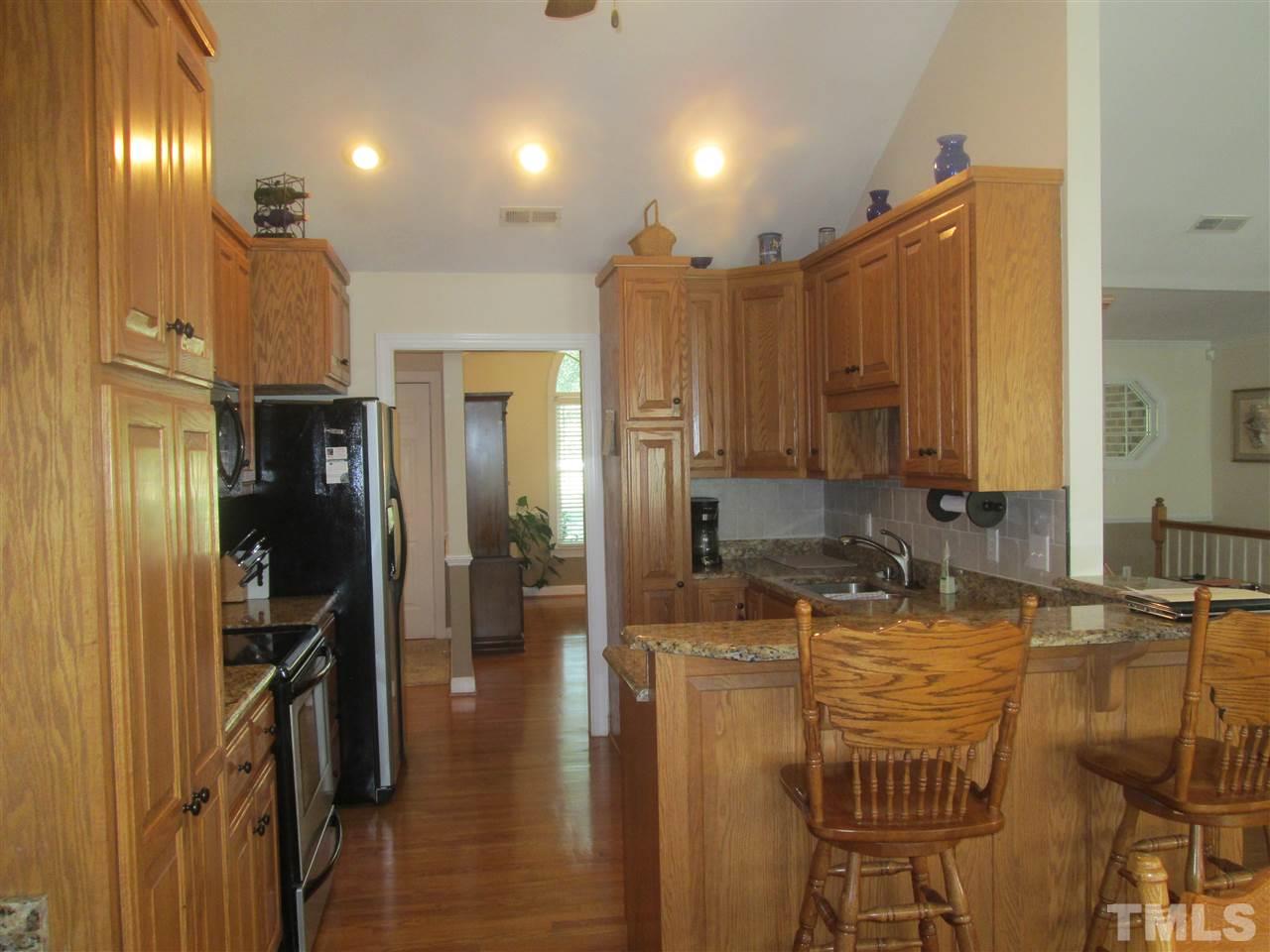 1654 Hayes Road Creedmoor, NC 27522 - Photo 8 of 25 Kitchen with upgraded granite, custom cabinets, stainless appliances