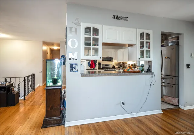a view of kitchen with stainless steel appliances granite countertop a refrigerator and a stove top oven
