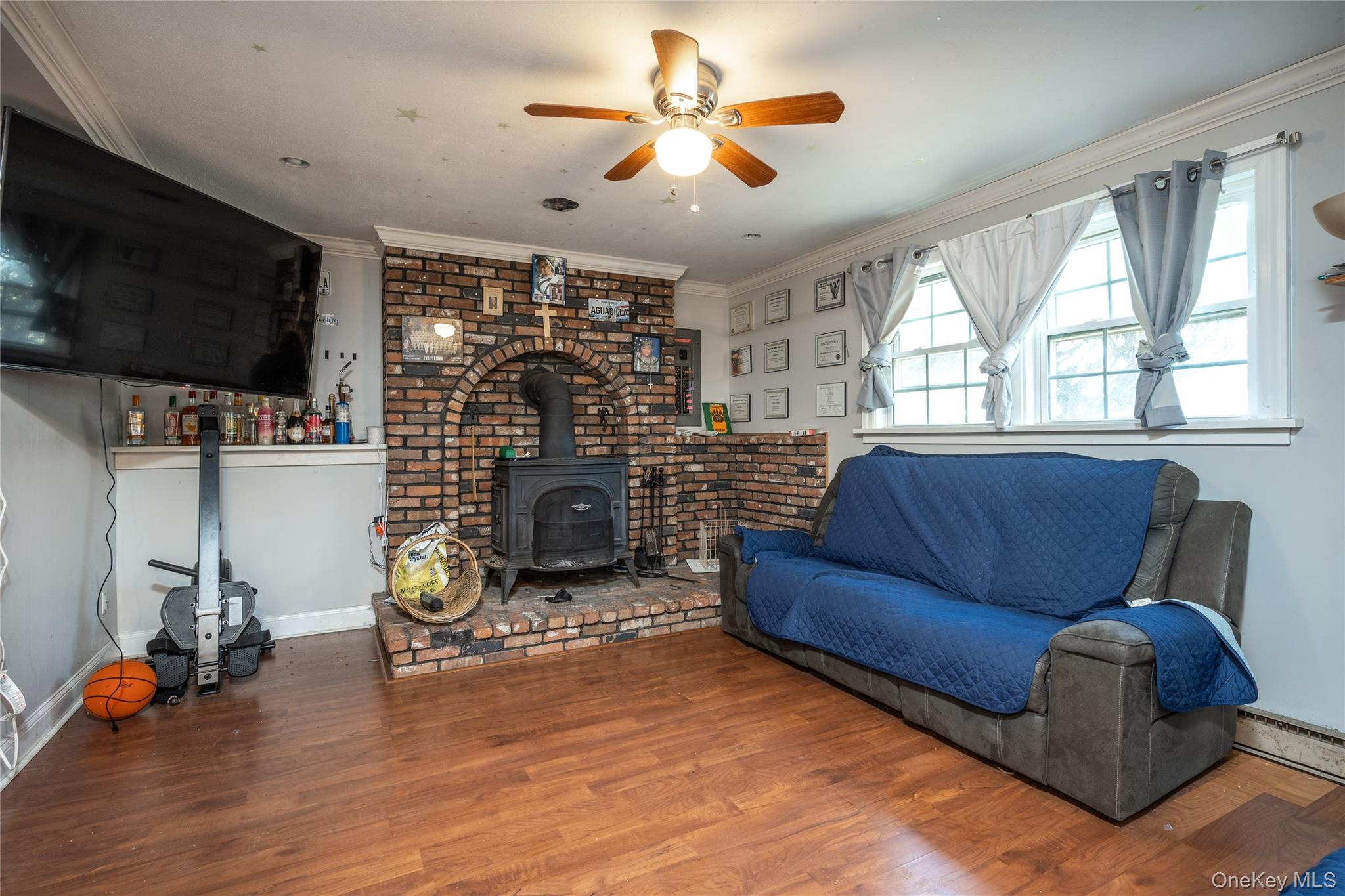76 Derick Drive Fishkill, NY 12524 - Photo 21 of 27 a living room with furniture a flat screen tv and a fireplace