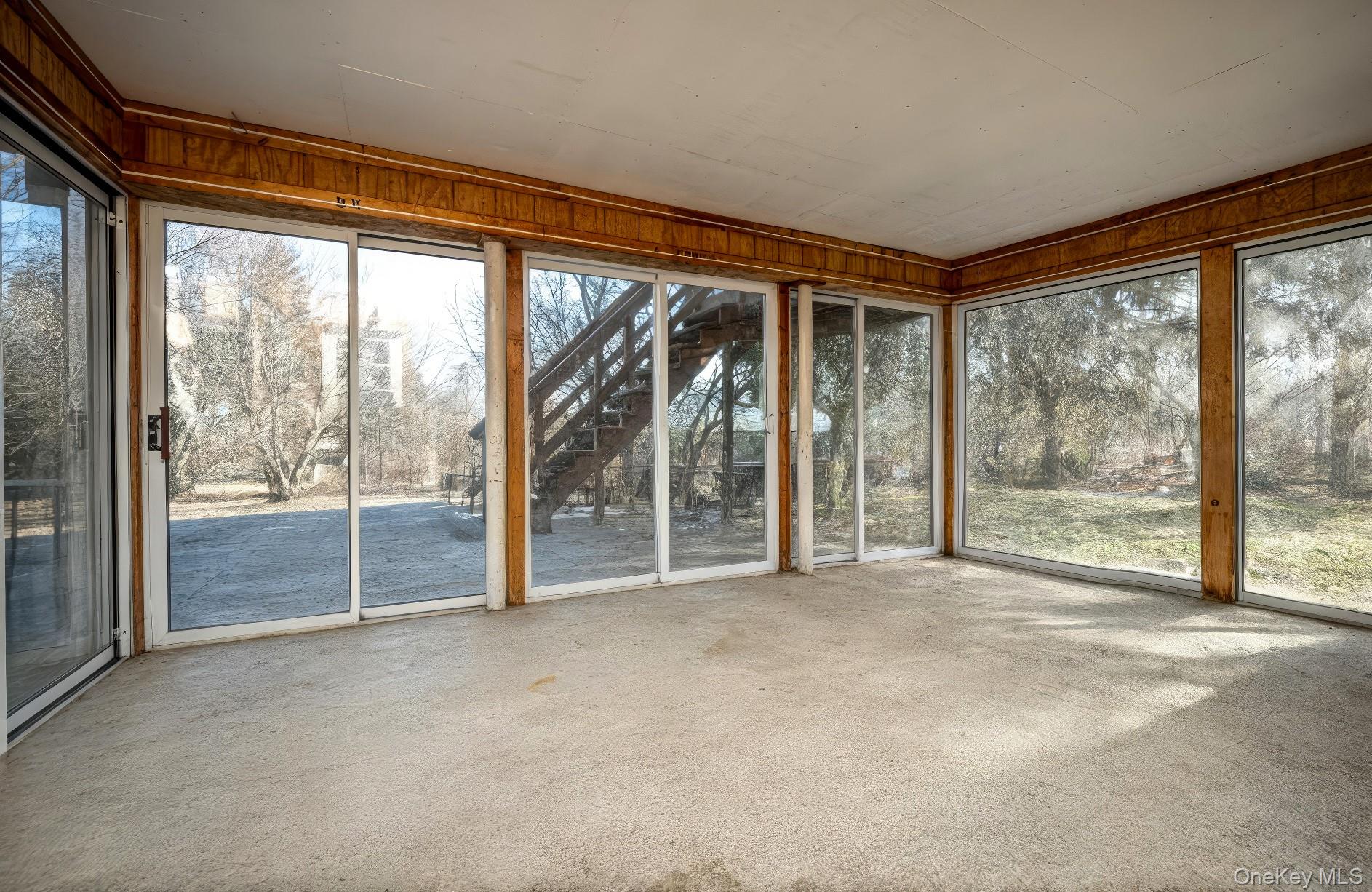 76 Derick Drive Fishkill, NY 12524 - Photo 22 of 27 an empty room with floor to ceiling windows and city view