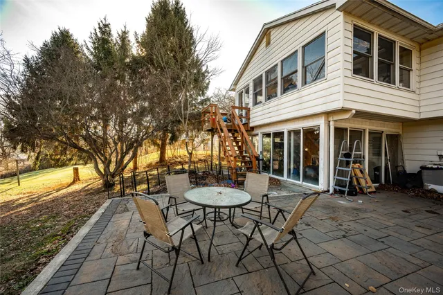 a view of a house with backyard and sitting area