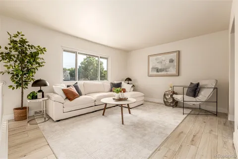 a living room with furniture and a potted plant