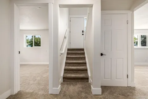 a view of a livingroom with a fireplace and window