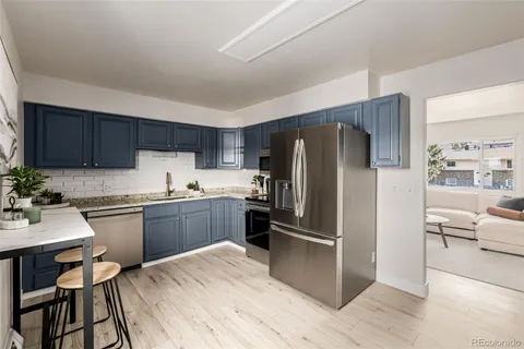 a kitchen with a refrigerator stove top oven and sink