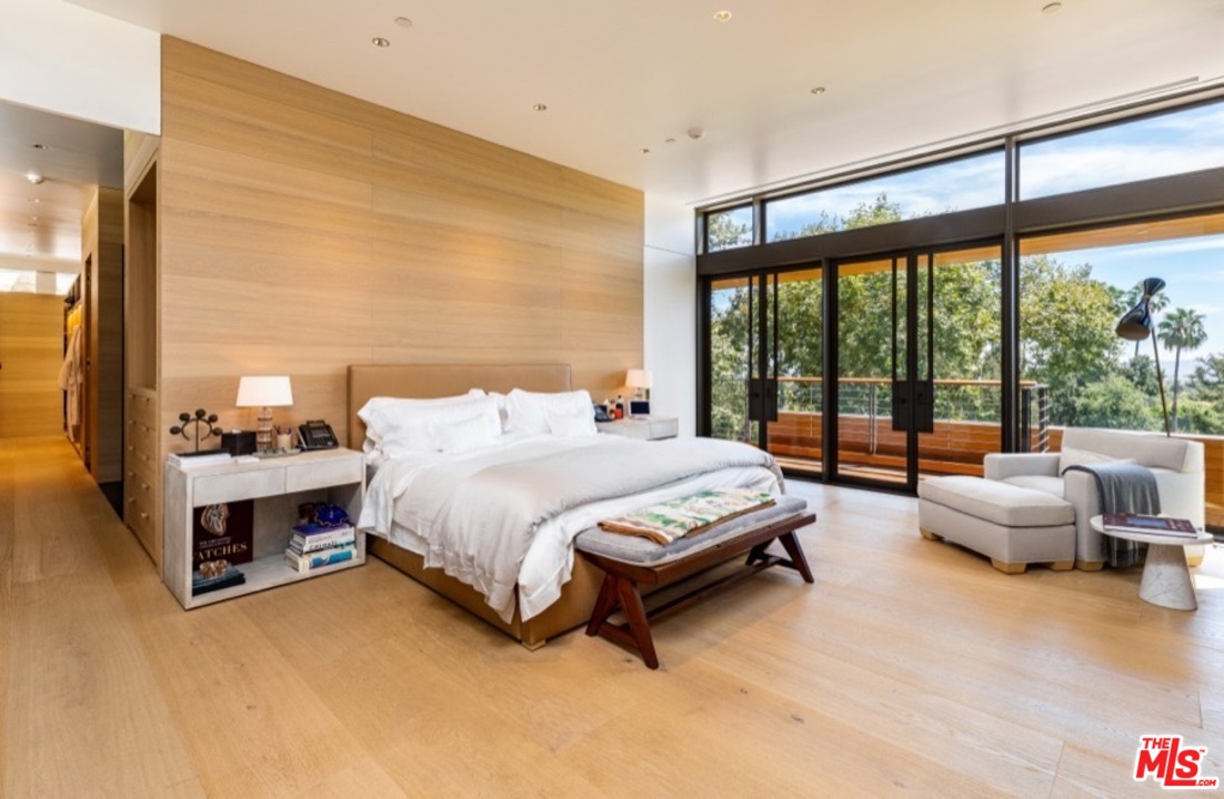 911 Foothill Road Beverly Hills, CA 90210 - Photo 13 of 21 a spacious bedroom with a bed and glass window