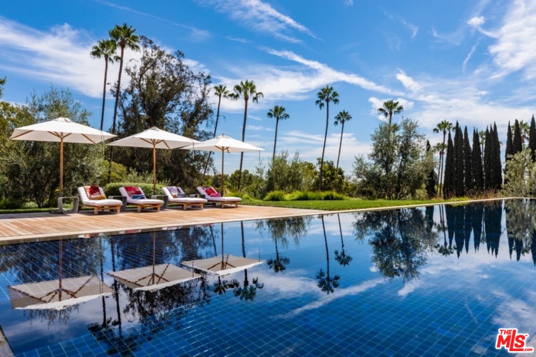 911 Foothill Road Beverly Hills, CA 90210 - Photo 16 of 21 a view of a swimming pool with sitting area and furniture