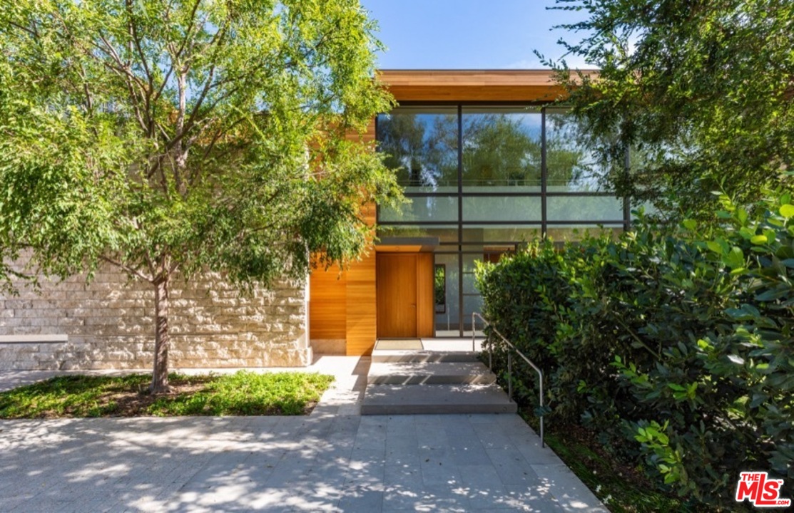 911 Foothill Road Beverly Hills, CA 90210 - Photo 4 of 21 a front view of a house with a yard