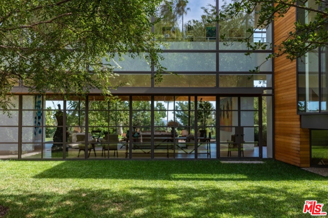 911 Foothill Road Beverly Hills, CA 90210 - Photo 5 of 21 a view of a garden from a living room