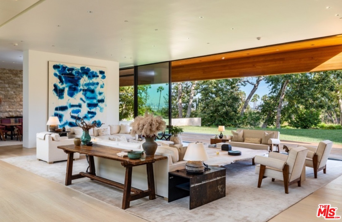 911 Foothill Road Beverly Hills, CA 90210 - Photo 7 of 21 a living room with patio furniture and a floor to ceiling window