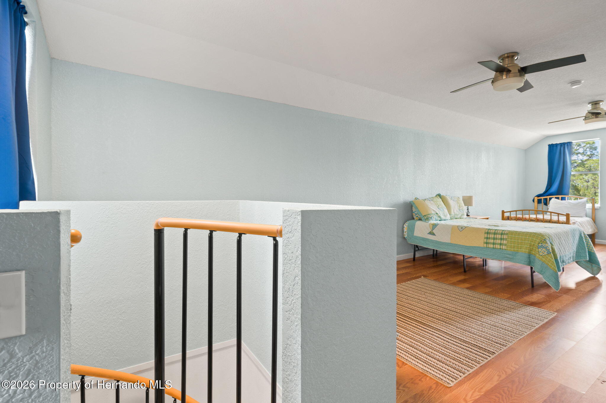 1566 Indian Bay Road Spring Hill, FL 34607 - Photo 35 of 56 a living room with furniture a rug and white walls