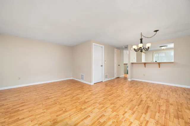a view of a kitchen with wooden floor and a ceiling fan