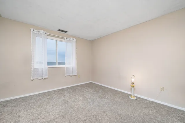 an empty room with a empty space and window