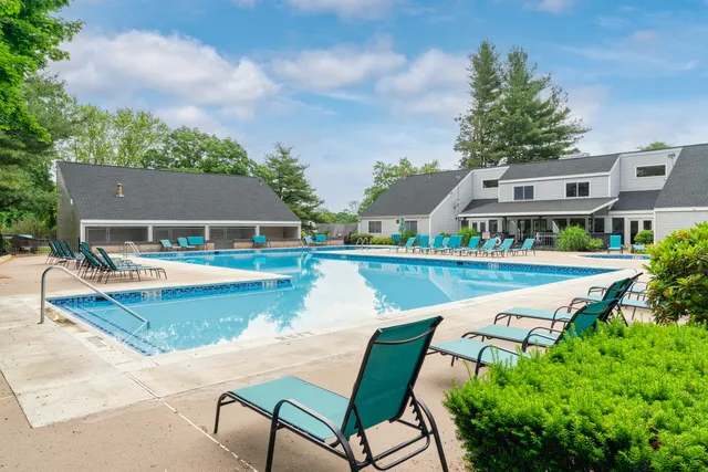 an aerial view of a house with swimming pool patio and outdoor seating