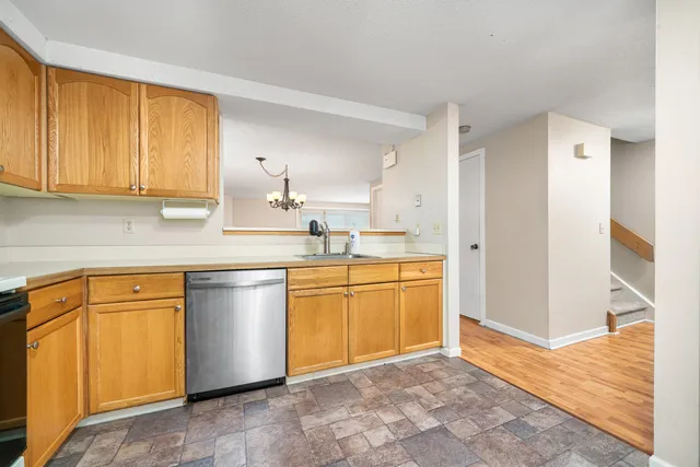 a kitchen with stainless steel appliances granite countertop a sink cabinets and granite counter tops