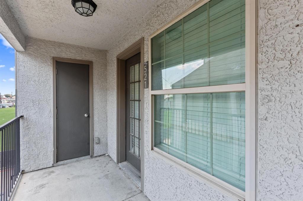 6108 Abrams Road, Unit 521 Dallas, TX 75231 - Photo 3 of 20 Private balcony featuring a concrete floor, a black metal railing, and a textured stucco exterior