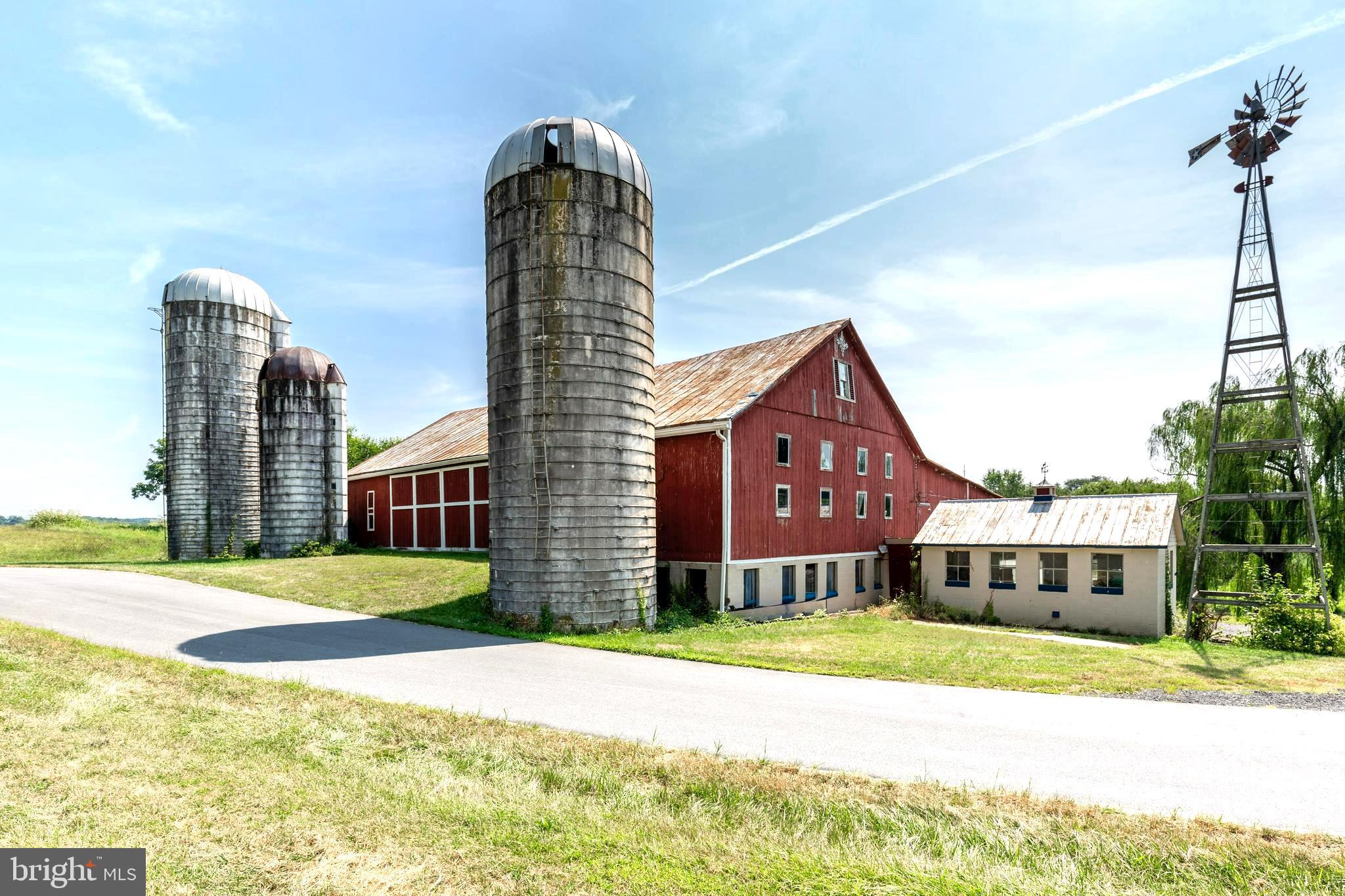 a front view of a building with a garden and plants