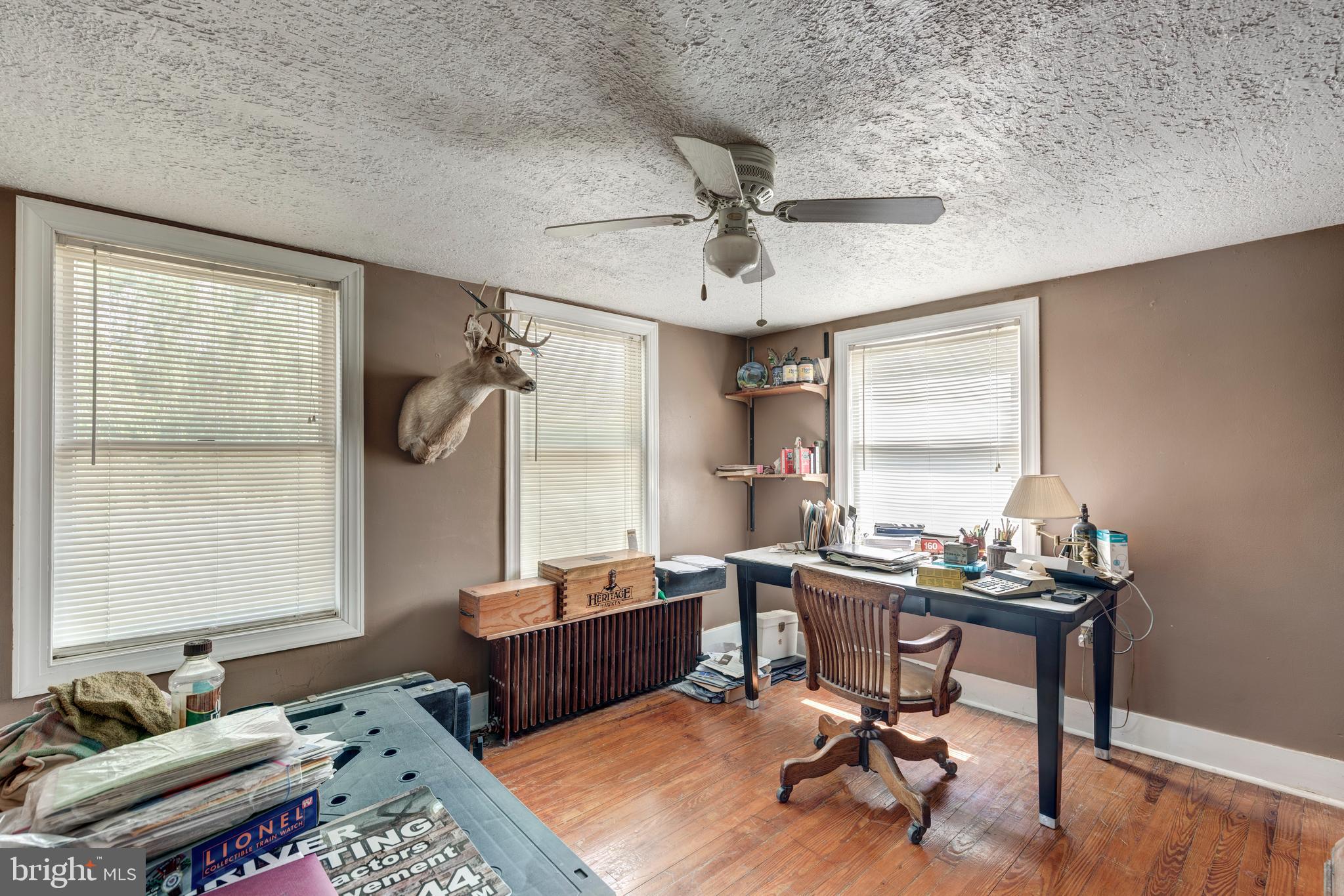 1845 Benson Road Westminster, MD 21158 - Photo 21 of 62 a view of a workspace with furniture and a window