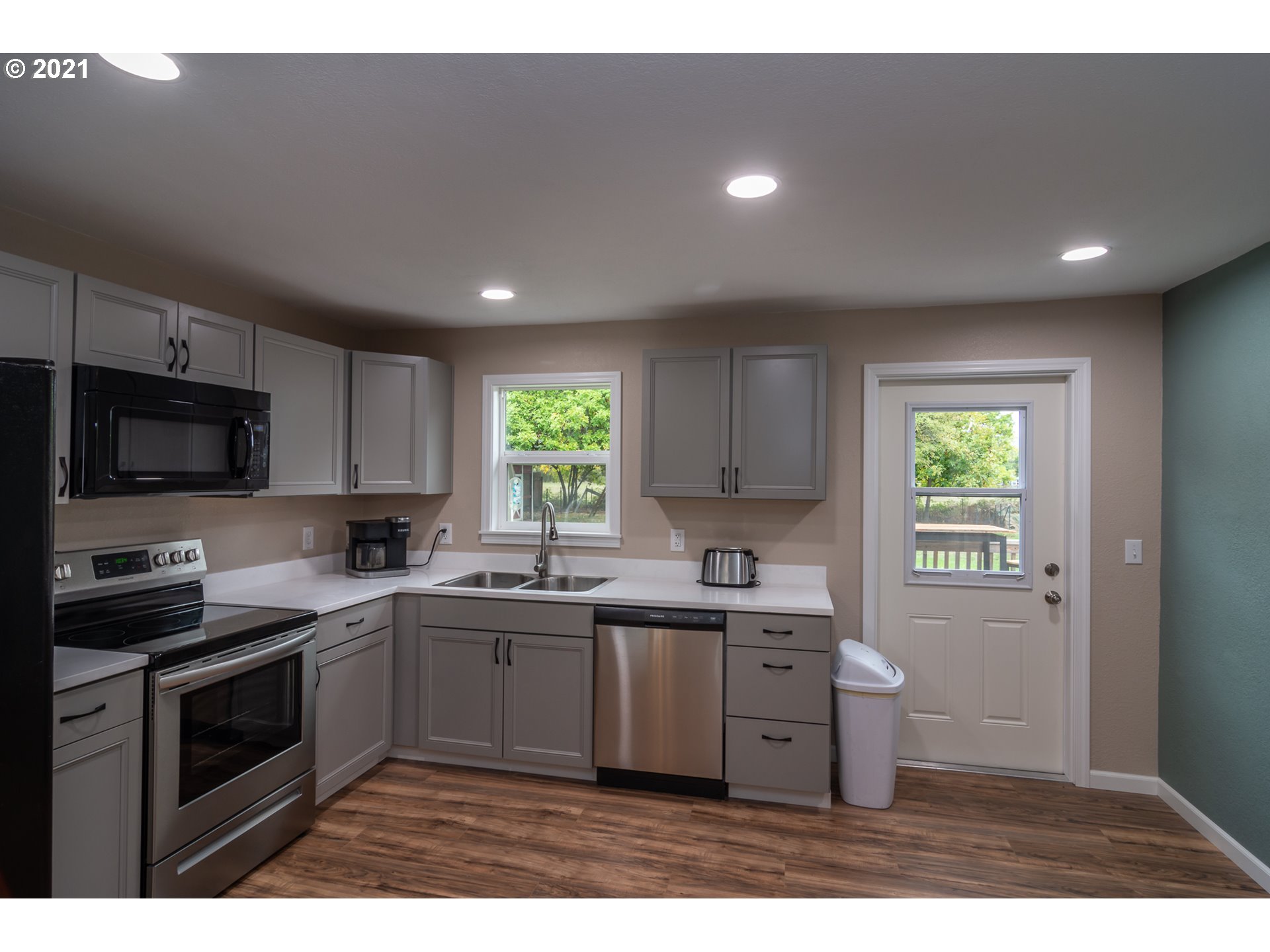 151 North Side Road Sutherlin, OR 97479 - Photo 6 of 27 a kitchen with a sink a stove a microwave and cabinets