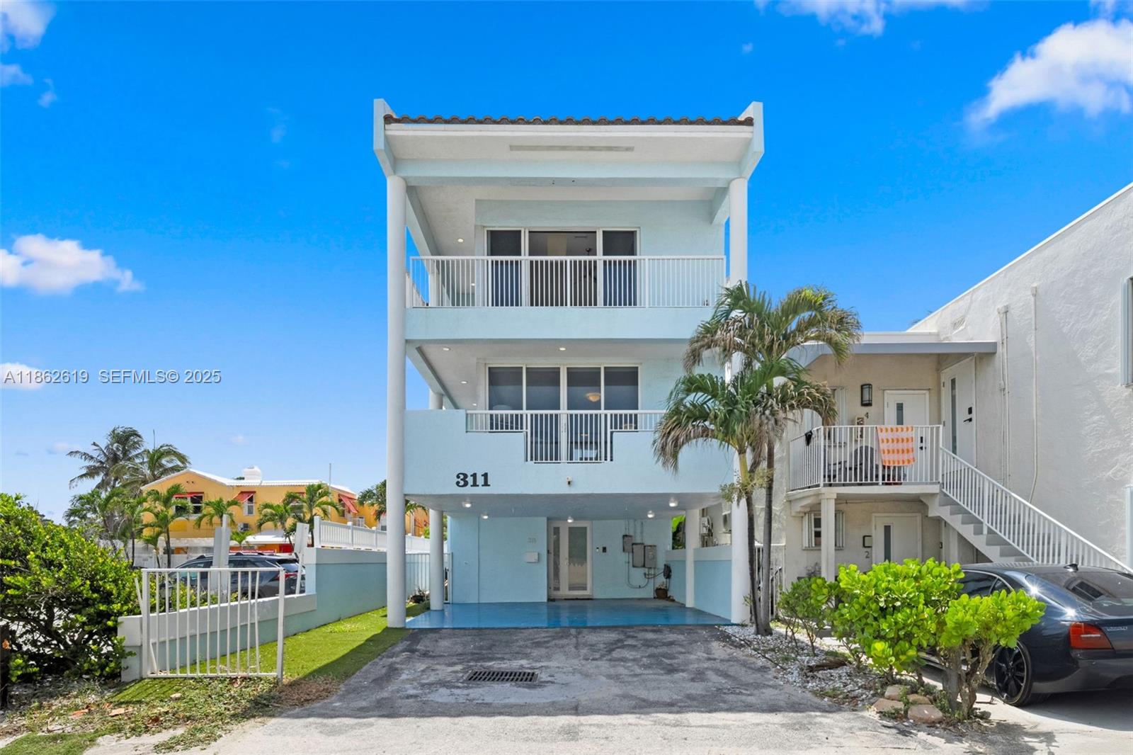 311 North Surf Road, Unit 311 Hollywood, FL 33019 - Photo 3 of 68 a front view of a house with a garden