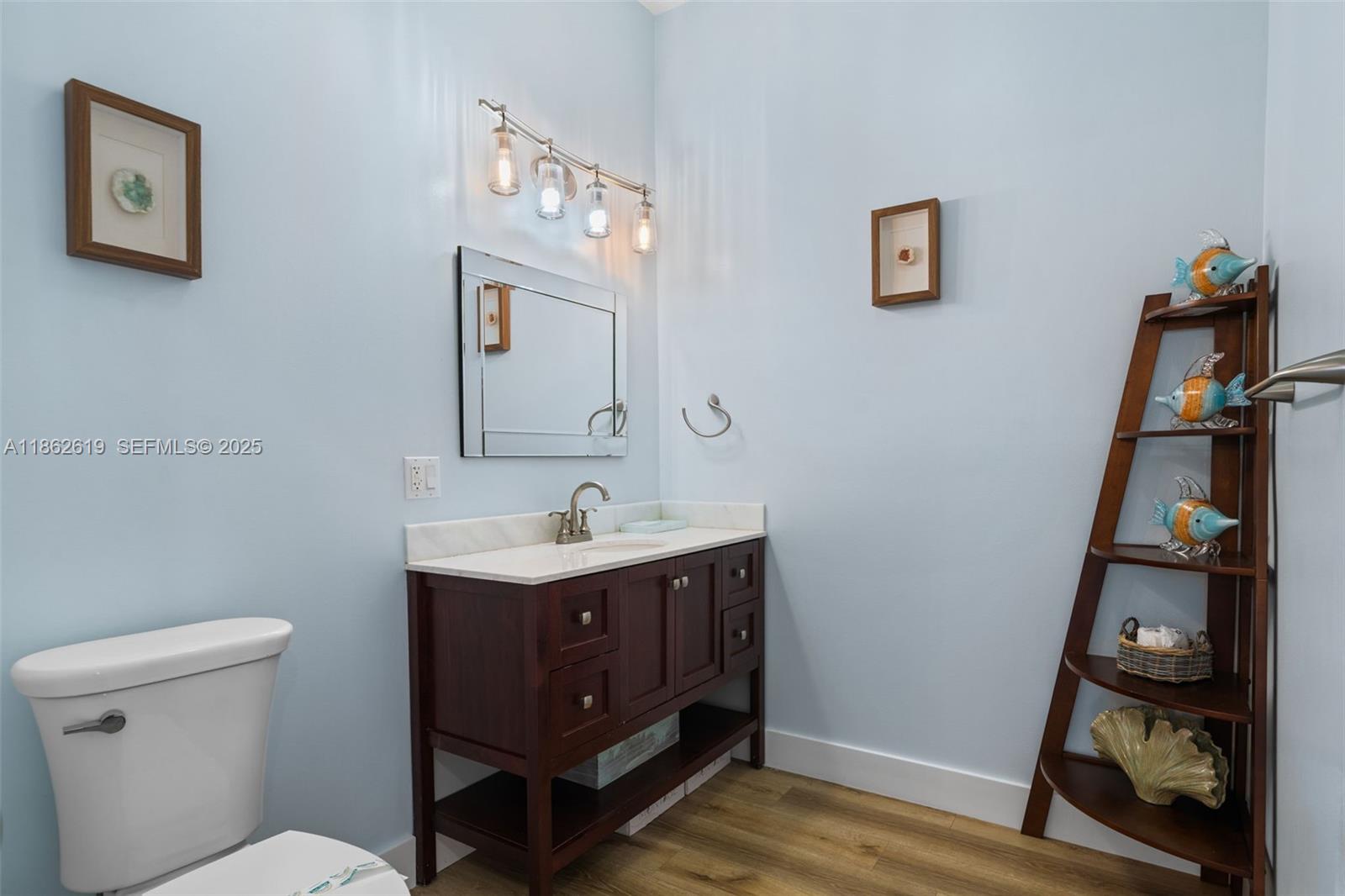 311 North Surf Road, Unit 311 Hollywood, FL 33019 - Photo 36 of 68 a bathroom with a toilet a sink and view of mirror