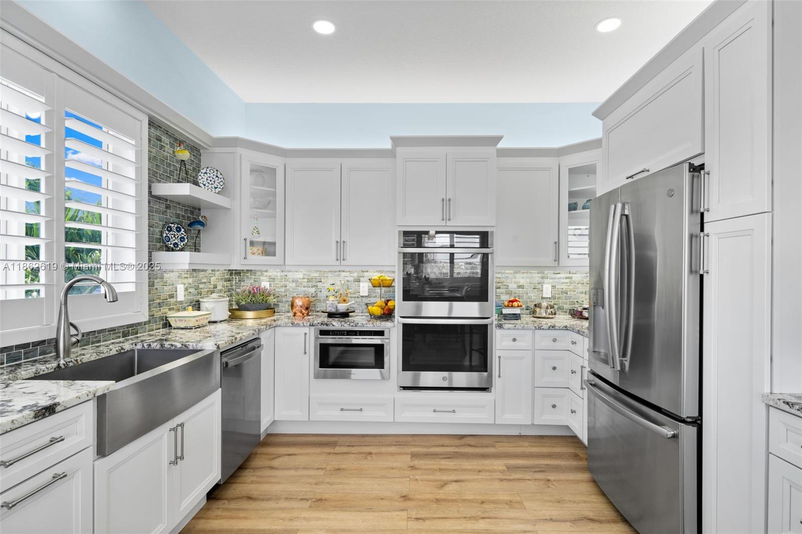 311 North Surf Road, Unit 311 Hollywood, FL 33019 - Photo 38 of 68 a kitchen with stainless steel appliances a refrigerator sink and microwave