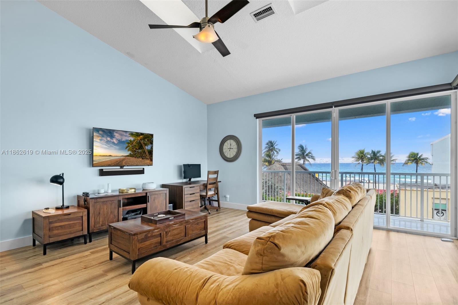 311 North Surf Road, Unit 311 Hollywood, FL 33019 - Photo 44 of 68 a living room with furniture and a floor to ceiling window