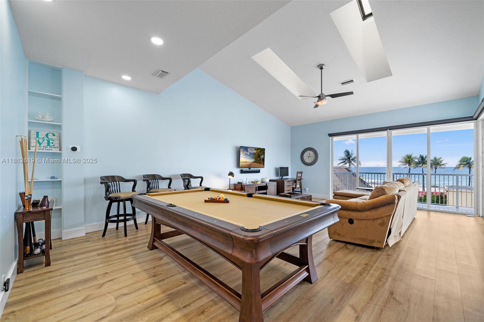 311 North Surf Road, Unit 311 Hollywood, FL 33019 - Photo 45 of 68 a living room with a table chairs and wooden floor