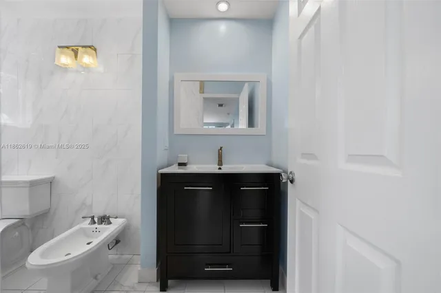 a bathroom with a sink a toilet and vanity