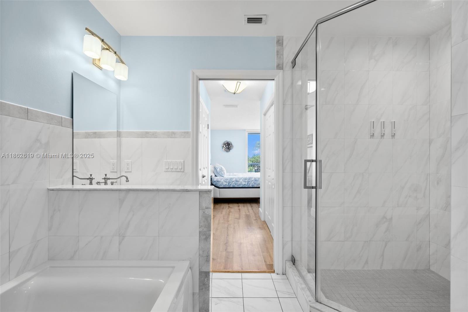 311 North Surf Road, Unit 311 Hollywood, FL 33019 - Photo 55 of 68 a bathroom with a tub and a shower