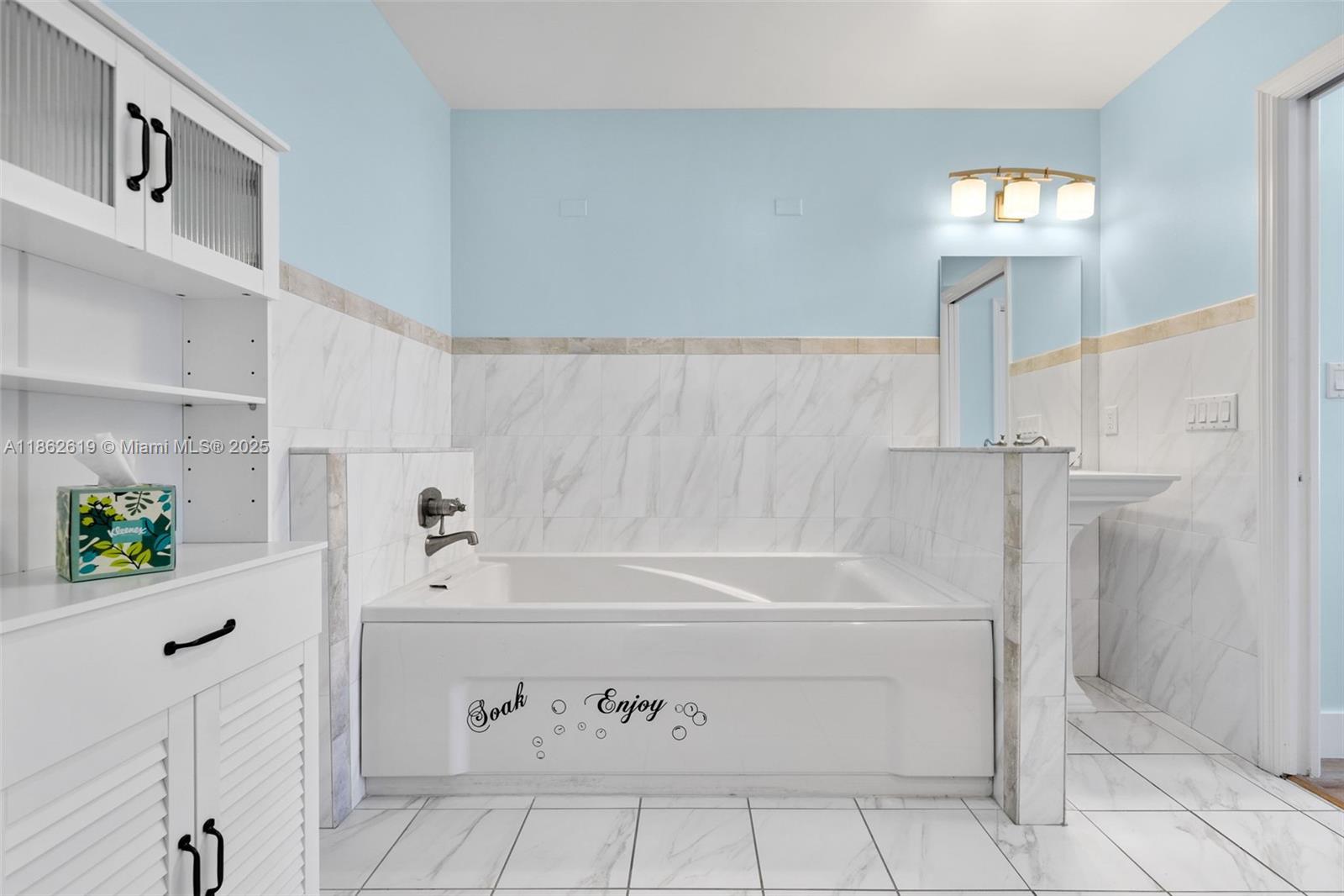 311 North Surf Road, Unit 311 Hollywood, FL 33019 - Photo 56 of 68 a bathroom with a bathtub sink and mirror