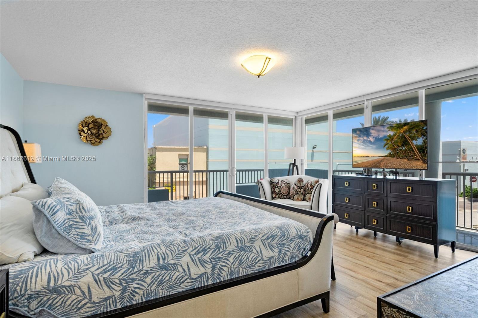 311 North Surf Road, Unit 311 Hollywood, FL 33019 - Photo 60 of 68 a bedroom with a bed and wooden floor