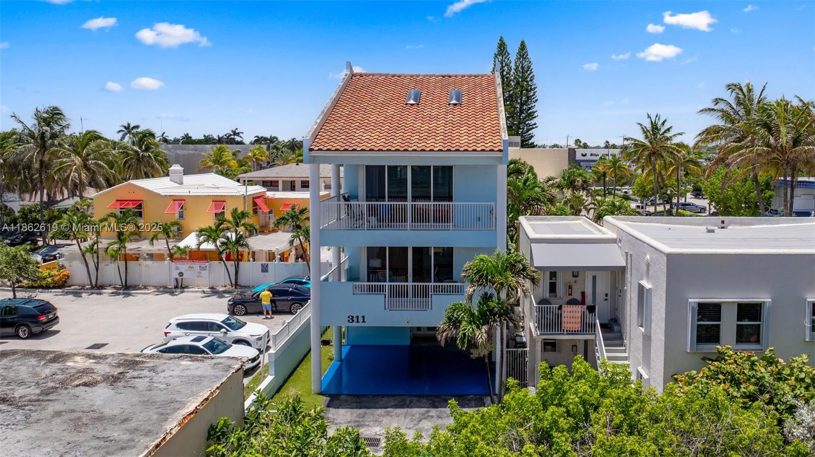 311 North Surf Road, Unit 311 Hollywood, FL 33019 - Photo 6 of 68 a front view of house with yard and outdoor seating