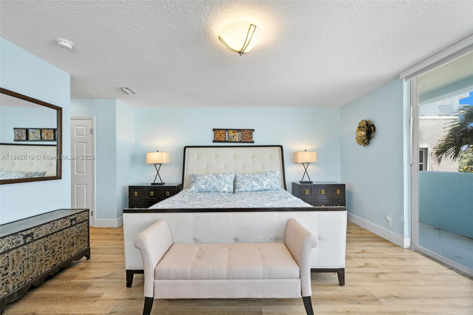 311 North Surf Road, Unit 311 Hollywood, FL 33019 - Photo 61 of 68 a bedroom with a bed and wooden floor
