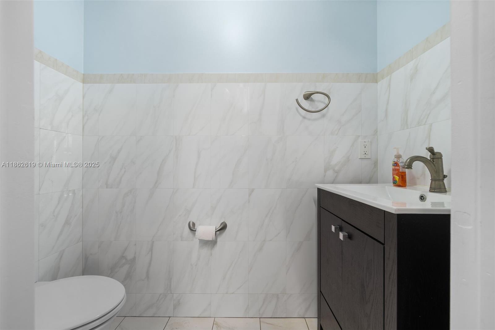 311 North Surf Road, Unit 311 Hollywood, FL 33019 - Photo 64 of 68 a bathroom with a sink a toilet and vanity