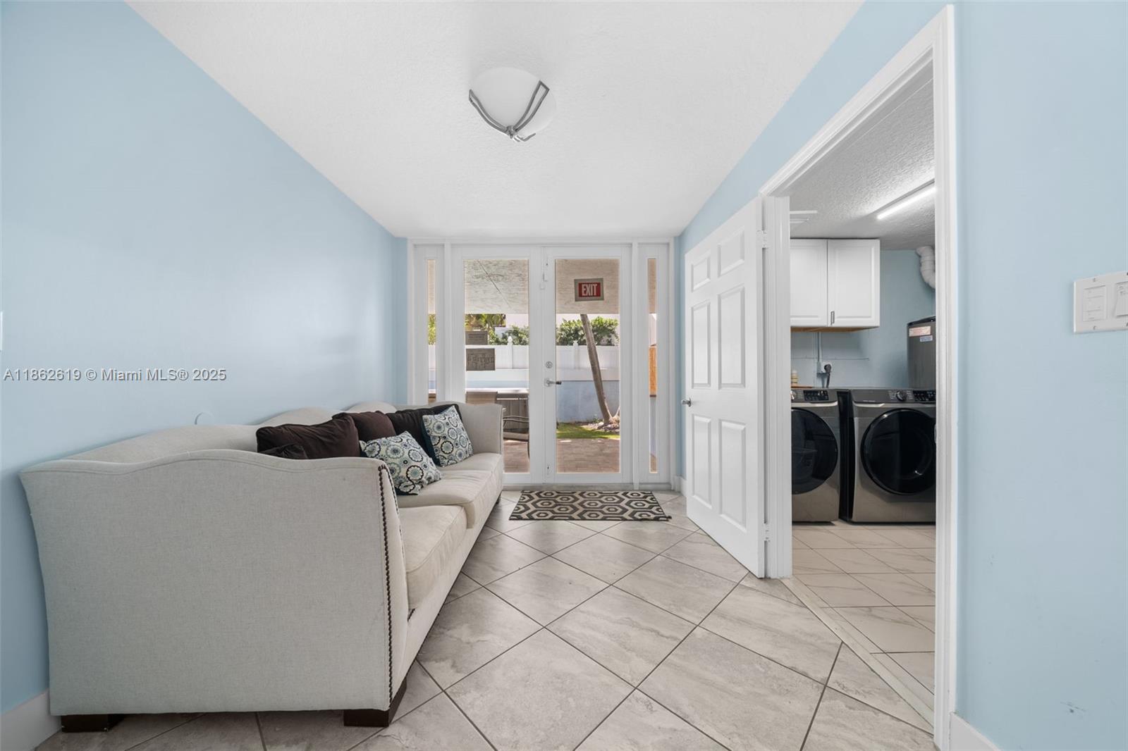 311 North Surf Road, Unit 311 Hollywood, FL 33019 - Photo 67 of 68 a living room with furniture and a chandelier