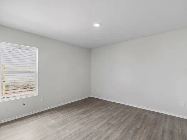 a view of an empty room and a window