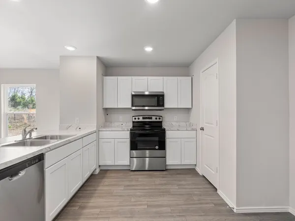 a kitchen with a sink and a stove top oven