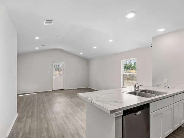 a kitchen with a sink and a mirror