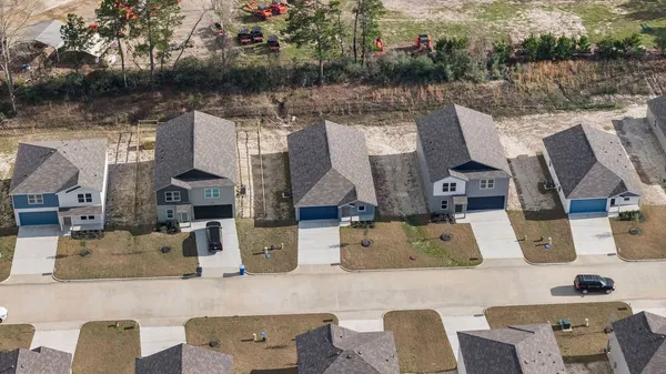 an aerial view of houses with outdoor space