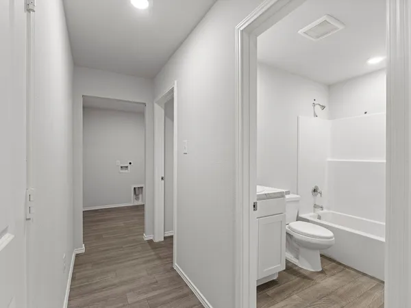 a bathroom with a granite countertop toilet a sink and a shower