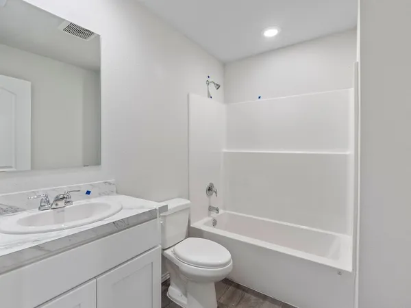 a bathroom with a sink a toilet and a bathtub