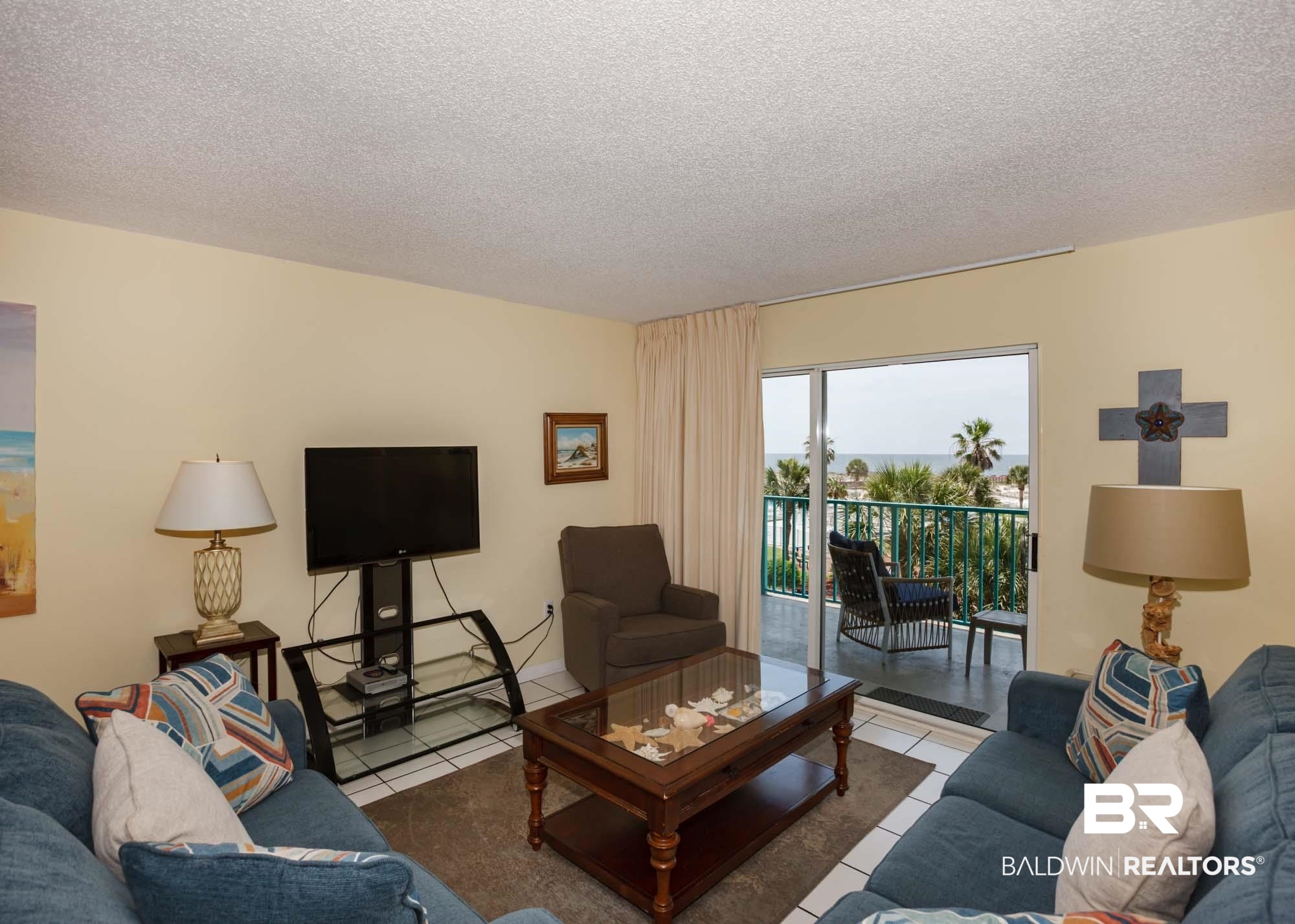 645 Plantation Road, Unit 6311 Gulf Shores, AL 36542 - Photo 34 of 43 Living area featuring tile patterned flooring and a textured ceiling