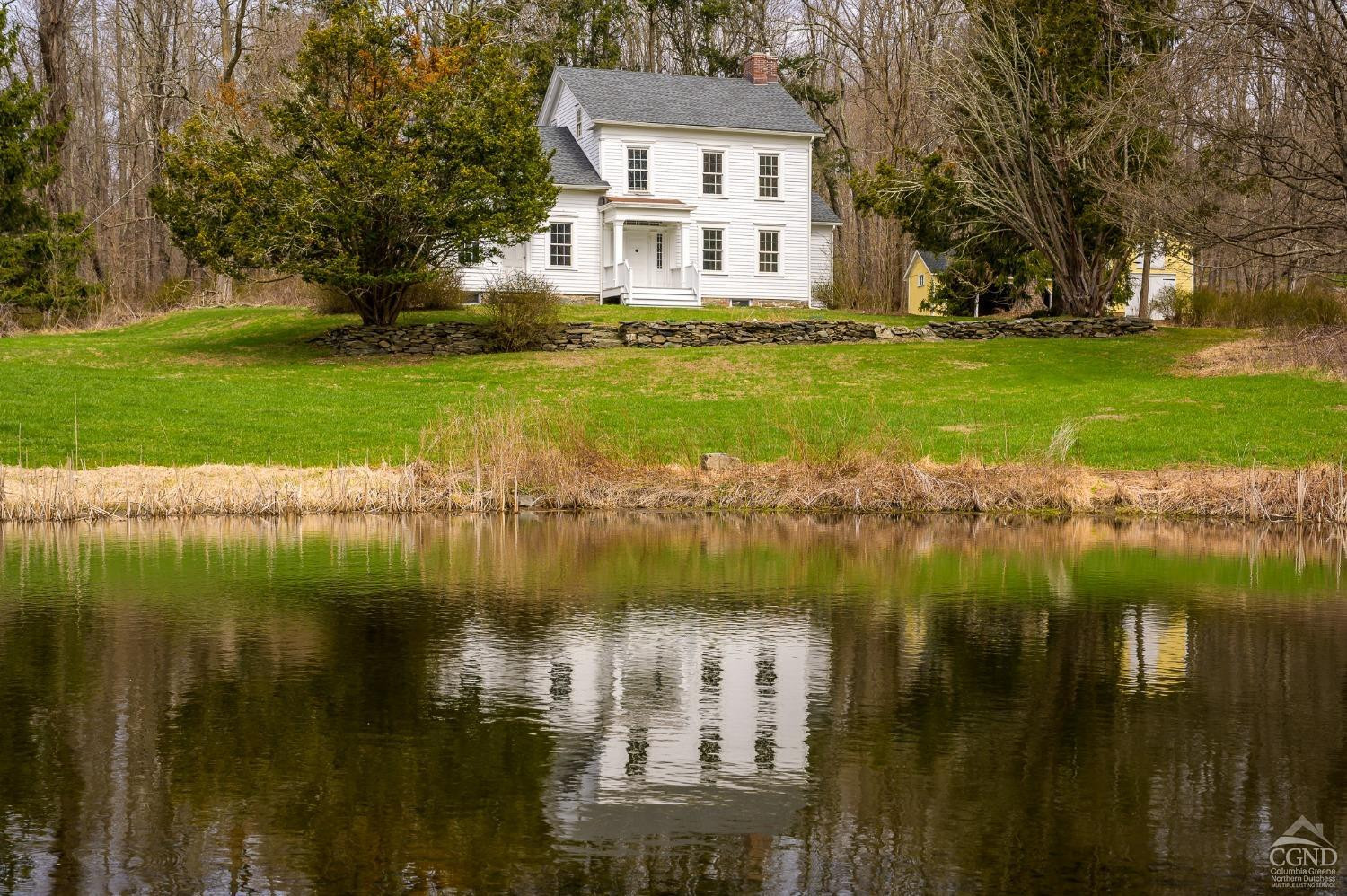 1606 Bulls Head Road Clinton Corners, NY 12514 - Photo 1 of 92 a view of a lake with a building in the background