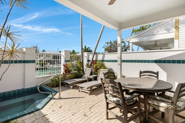 a roof deck with table and chairs